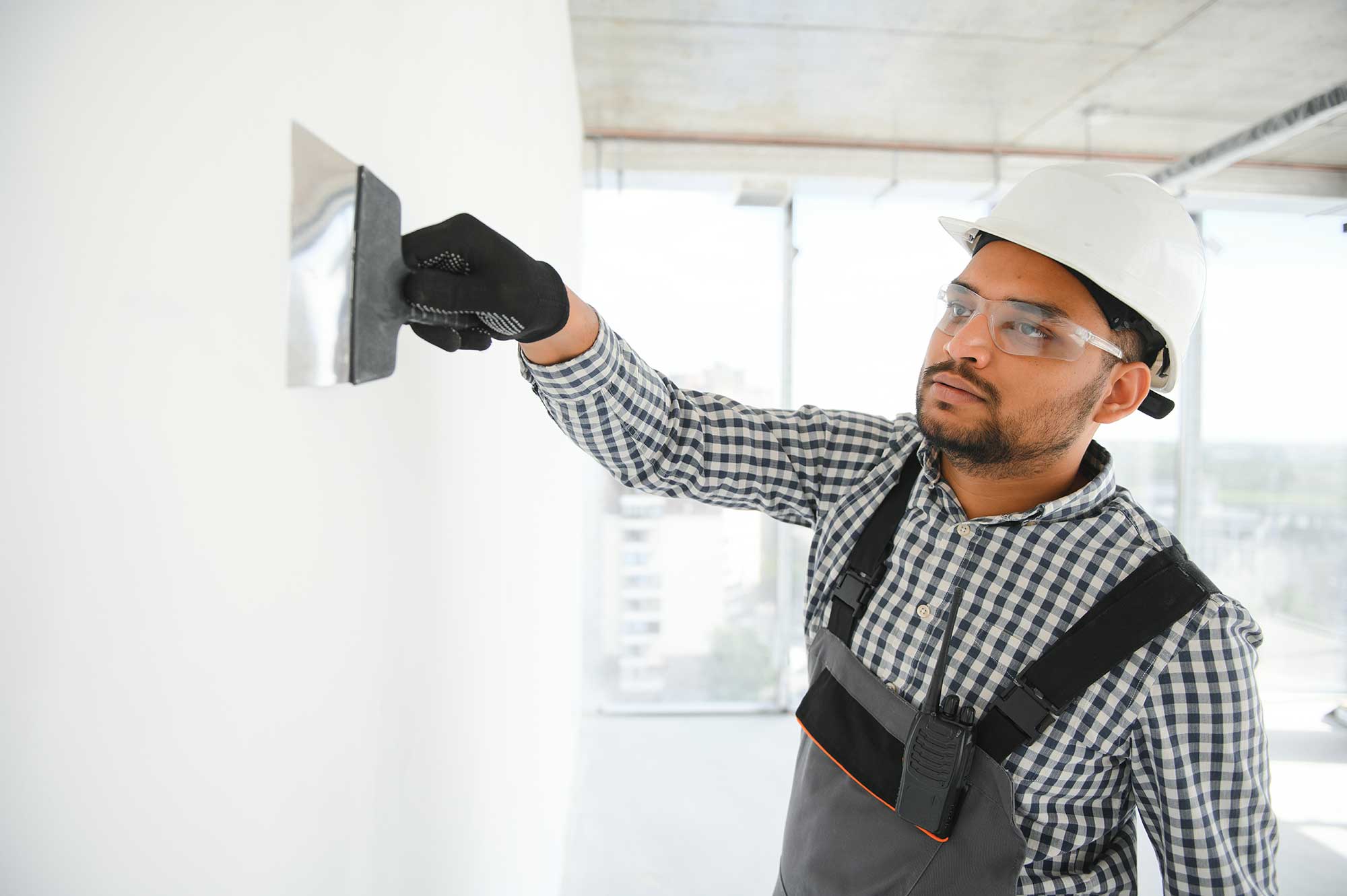 indian-worker-spreading-plaster-to-wall-with-trowe-2025-03-15-18-39-12-utc